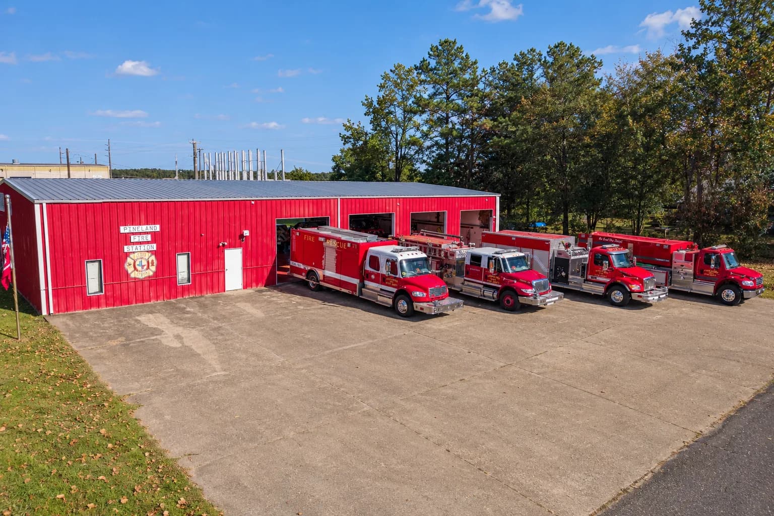 Pineland Fire Station with four department trucks lined up on the apron