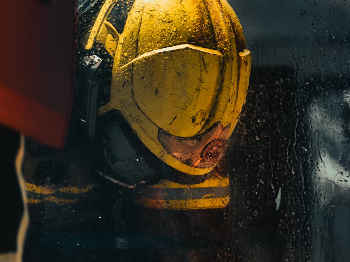 A well-worn helmet seen through rain on the truck window